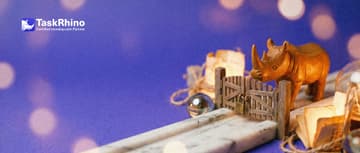 A small wooden rhino stands at a small wooden gate with a brass padlock across a marble track; a glass marble waits behind the closed gate.