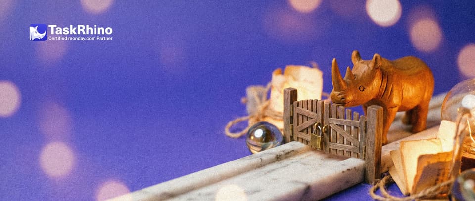 A small wooden rhino stands at a small wooden gate with a brass padlock across a marble track; a glass marble waits behind the closed gate.