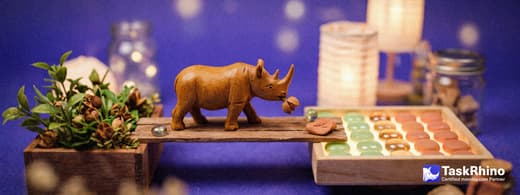 A small wooden rhino carries items from a leafy green planter box holding small seed pods into a tidy board of coloured tiles, nothing dropped on the way.