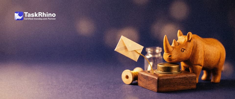 A small wooden rhino presses a large round brass push button with its foot; a tiny paper envelope flies out of a slot on a golden thread.