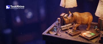 A small wooden rhino presses a brass button on one small tile board; a golden thread runs to a second board where one tile glows from amber to green.