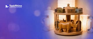 A small wooden rhino turns a small wooden carousel that carries ten tiny, different tool chests, picking one as it comes round.