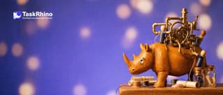 A small wooden rhino looks up, overwhelmed, at a huge tangled brass machine of pipes and gears with tiny wooden peg engineers climbing it.