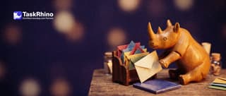 A small wooden rhino picks one envelope from a fan of differently coloured envelopes in a little wooden rack, matching it to a coloured tile.