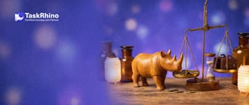 A small wooden rhino sets brass coins on one pan of a balance scale against small leather briefcases and an hourglass on the other.