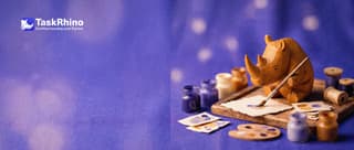 A small wooden rhino paints a paper form card in custom colours with a small brush, little paint pots around it.