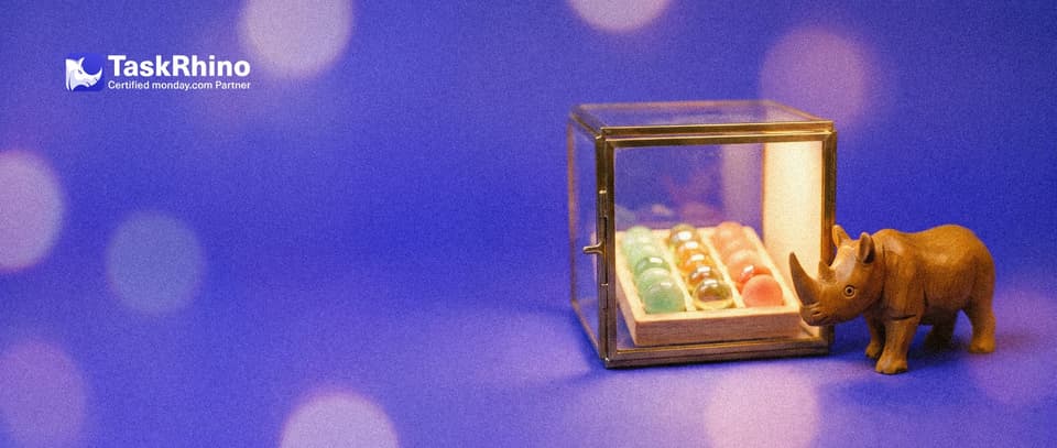 A small wooden rhino stands guard at the door of a small glass and brass vault holding a tidy board of coloured tiles.