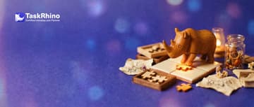 A small wooden rhino slots small wooden add-on pieces like puzzle pieces into the edge of a tile board.