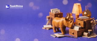 A small wooden rhino files a mini tile board into one of several nested small wooden drawers that each hold boards.