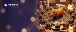 A small wooden rhino stands in the middle of a circular golden track where brass coins roll round and round, ten tiny tool chests along the edge.