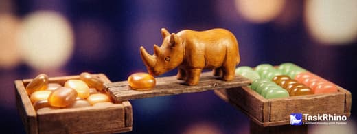 A small wooden rhino carries items from a second identical tile tray into a tidy board of coloured tiles, nothing dropped on the way.