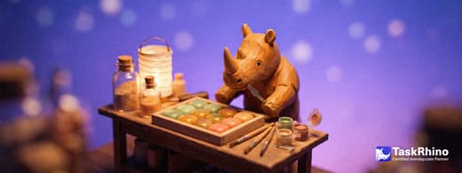 A small wooden rhino at a workbench reshapes a tidy board of colored tiles, adding new custom-colored tiles from small paint pots, with a tiny carving knife and brushes nearby.