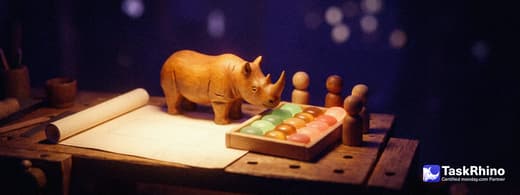 A small wooden rhino and four small wooden peg figures assemble a tidy board of colored tiles from parts laid out on a workbench beside an unrolled plain paper plan.