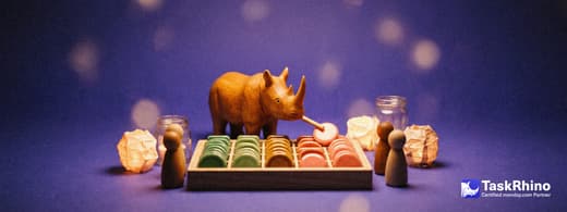 A small wooden rhino leads a small class of wooden peg figures around a tidy board of colored tiles, pointing at one tile with a little wooden pointer.