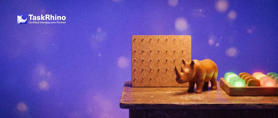 A small wooden rhino stands between two tiny wooden doors standing open: through one a simple paper wall planner, through the other a tidy board of coloured tiles.
