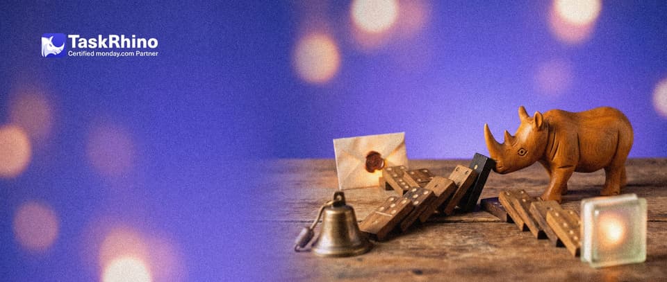 A small wooden rhino tips a single domino that sets off three branching lines of dominoes ending at a tiny bell, an envelope and a glowing tile.