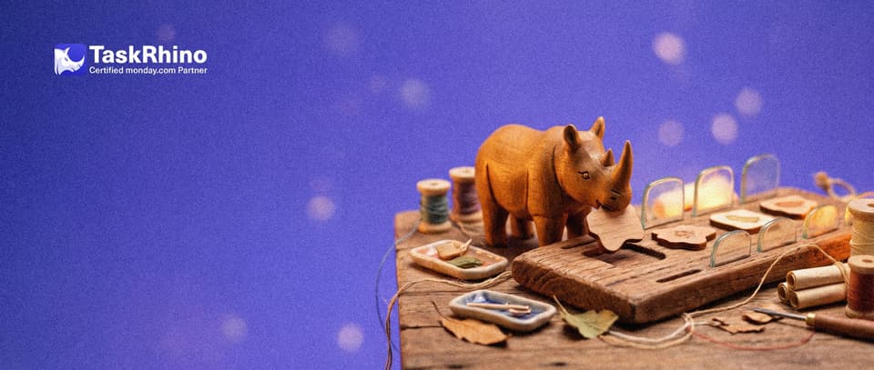 A small wooden rhino places a new tile over an open slot on a board where some tiles sit safely under tiny glass shields.