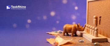 A small wooden rhino looks at a column of tiny wooden peg figures standing in slots on a paper form card; on a public notice board behind, the same slot is empty.