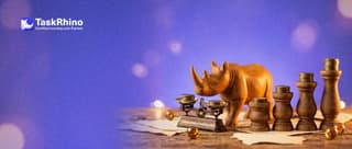 A small wooden rhino weighs coins on a tiny scale in front of four wooden pedestals of increasing height, each with a stack of brass coins.
