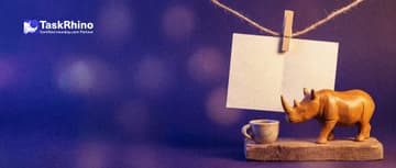 A small wooden rhino steps away for a teacup break from a half-filled paper form card hung by a wooden clothes peg on a little string.