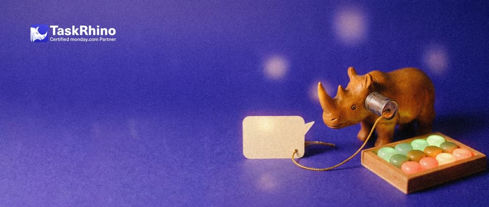 A small wooden rhino holds a tin-can telephone to its ear; the golden string runs from a small paper speech bubble to a tidy board of coloured tiles.