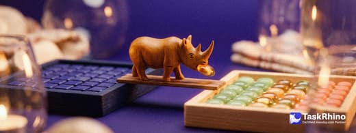 A small wooden rhino carries items from a navy wooden tray of small square tiles in strict rows into a tidy board of coloured tiles, nothing dropped on the way.