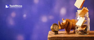 A small wooden rhino checks a small brass gauge beside a glass jar almost full of tokens as paper form cards drop in.