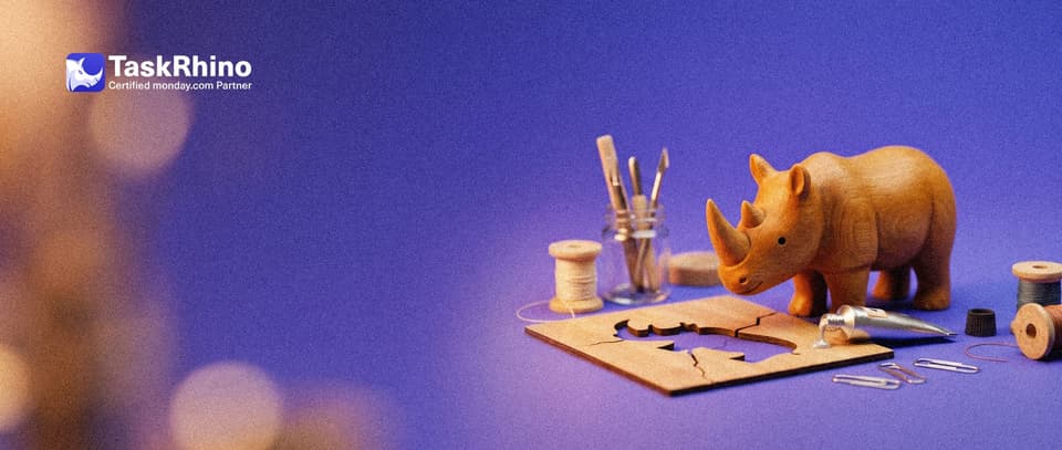 A small wooden rhino mends a cracked wooden stencil with a tiny tube of glue and paper clips.