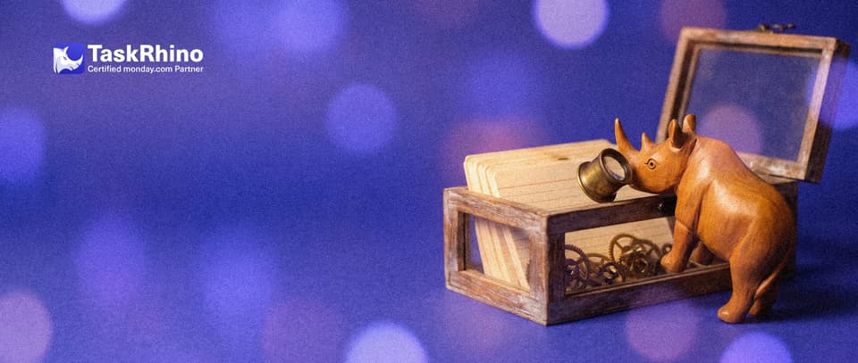A small wooden rhino inspects an open wooden crate with glass sides full of neat index cards and gears through a brass loupe.