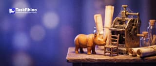 A small wooden rhino gently nudges a small empty chair toward a dusty, cobwebbed brass machine that nobody is using.