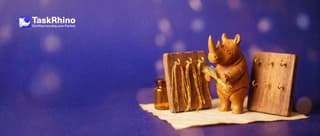 A small wooden rhino holds a bundle of golden threads: the original board has small brass hooks holding them, the copy board beside it has empty hooks.