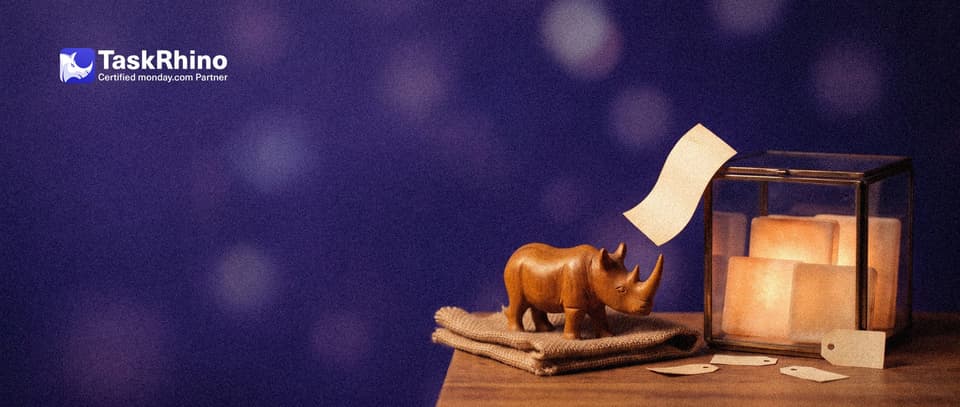 A small wooden rhino watches a paper form card bounce off a sealed glass case holding glowing board tiles.