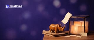 A small wooden rhino watches a paper form card bounce off a sealed glass case holding glowing board tiles.