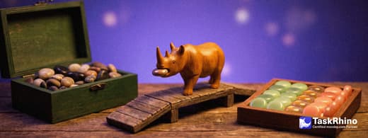 A small wooden rhino carries items from a dark green wooden box of small polished stones into a tidy board of coloured tiles, nothing dropped on the way.